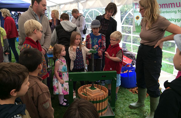 Children using an apple press